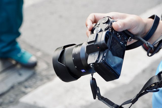 A close up shot of a persons hand holding a camera